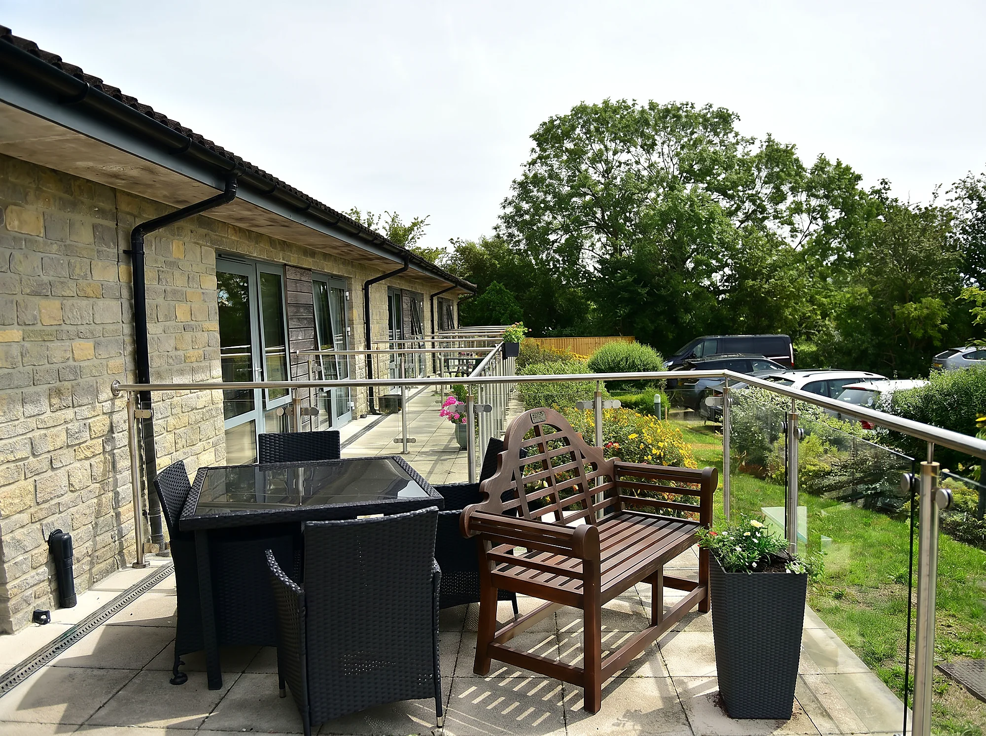 The sunny terrace at Castle House, with seating overlooking the gardens