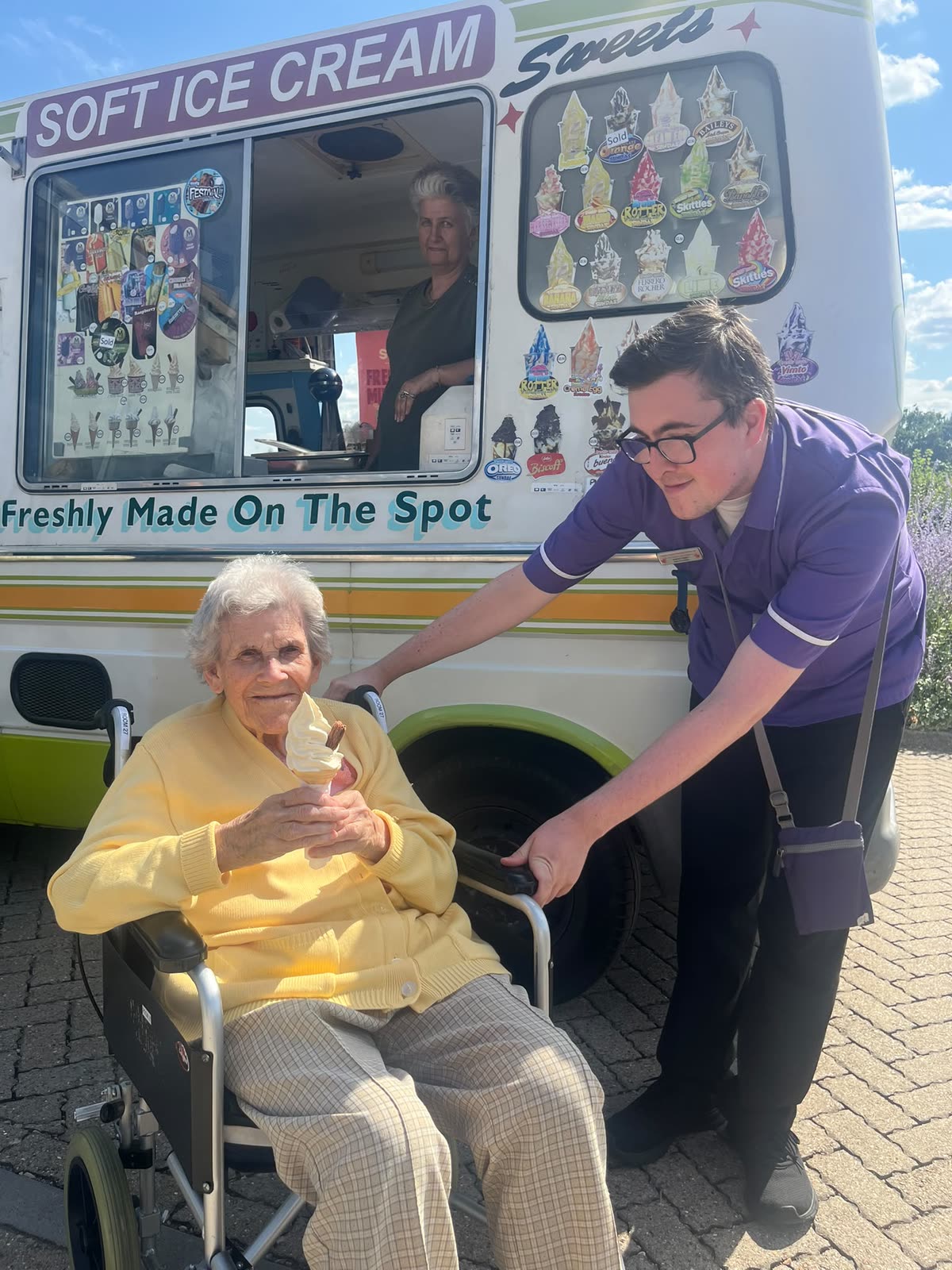A resident enjoying an ice cream by the van with one of our team